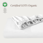 A single fitted sheet folded neatly showing part of the elastic. The fitted sheet is Certified GOTS Organic.