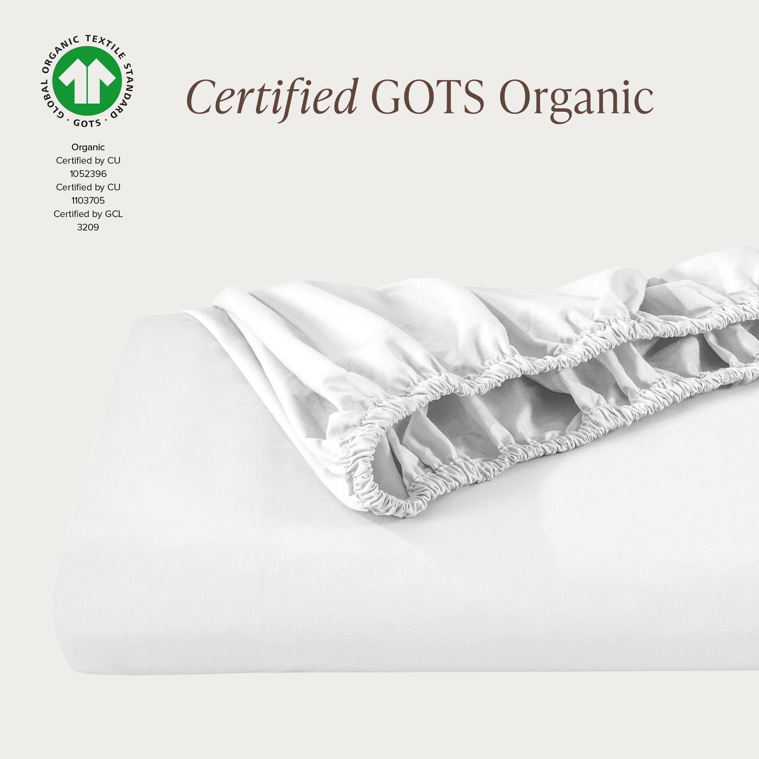 A single fitted sheet folded neatly showing part of the elastic. The fitted sheet is Certified GOTS Organic.
