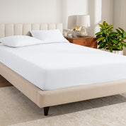 A single organic cotton percale fitted sheet on a bed