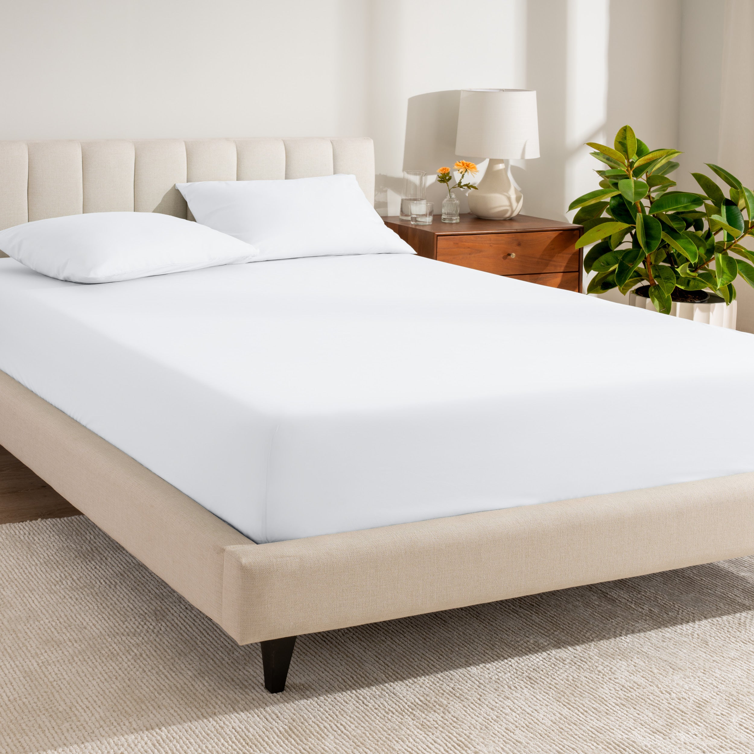 A single organic cotton percale fitted sheet on a bed