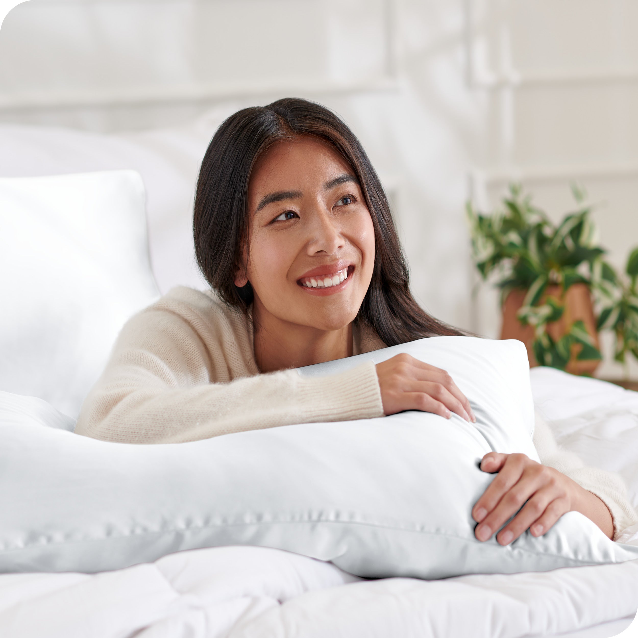 A woman resting her arm on a pillow