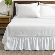 A wrap around bed skirt on a bed