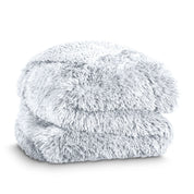 A shaggy faux fur blanket folded