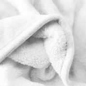 Close up of sherpa blanket showing texture of velvety soft side and sherpa backing