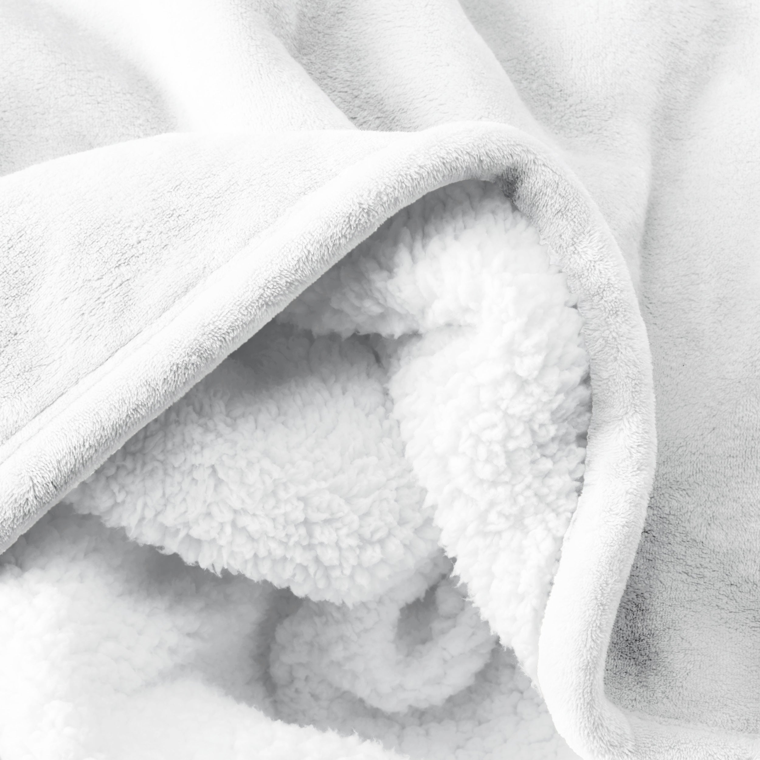 Close up of sherpa blanket showing texture of velvety soft side and sherpa backing
