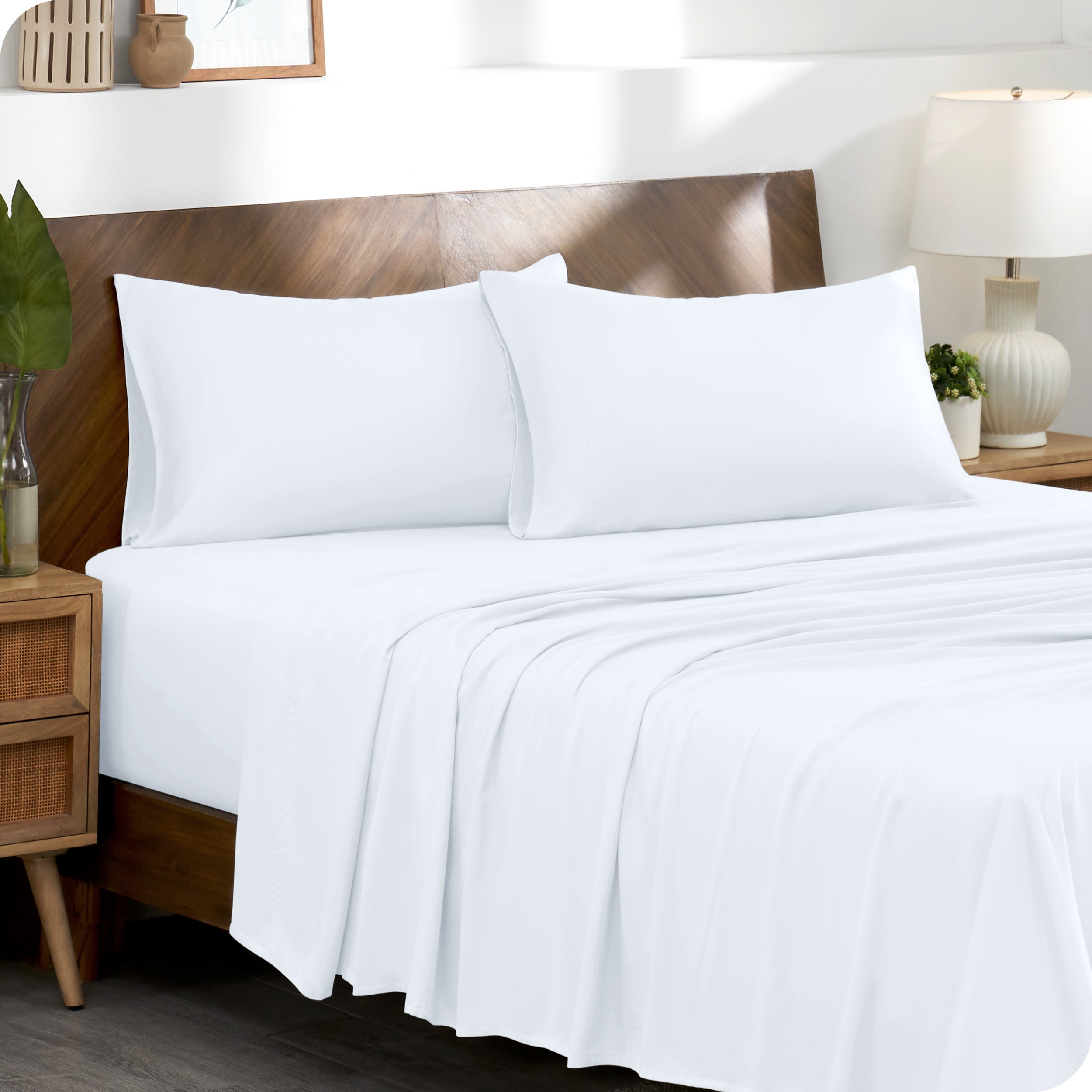 TENCEL™ pillowcases on pillows near a wooden headboard