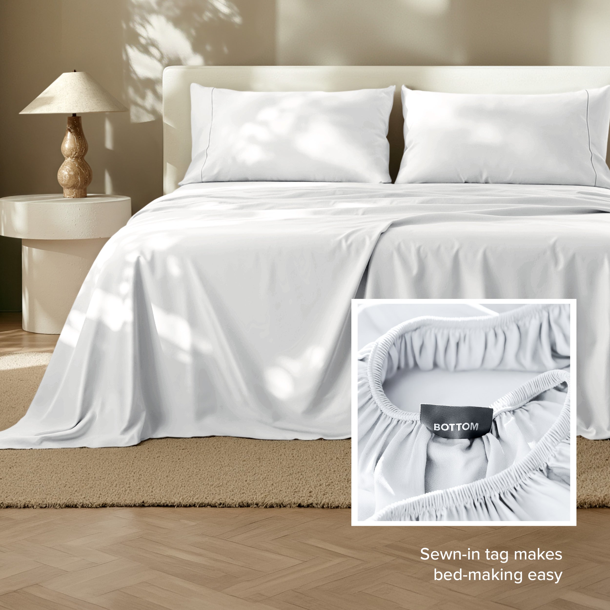 Tencel bed sheets on a bed with a lamp and side table in the background.