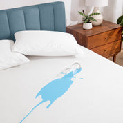 A glass of water spilled on a mattress protector