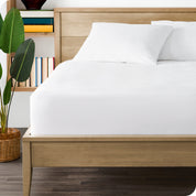 A bed made with a mattress protector