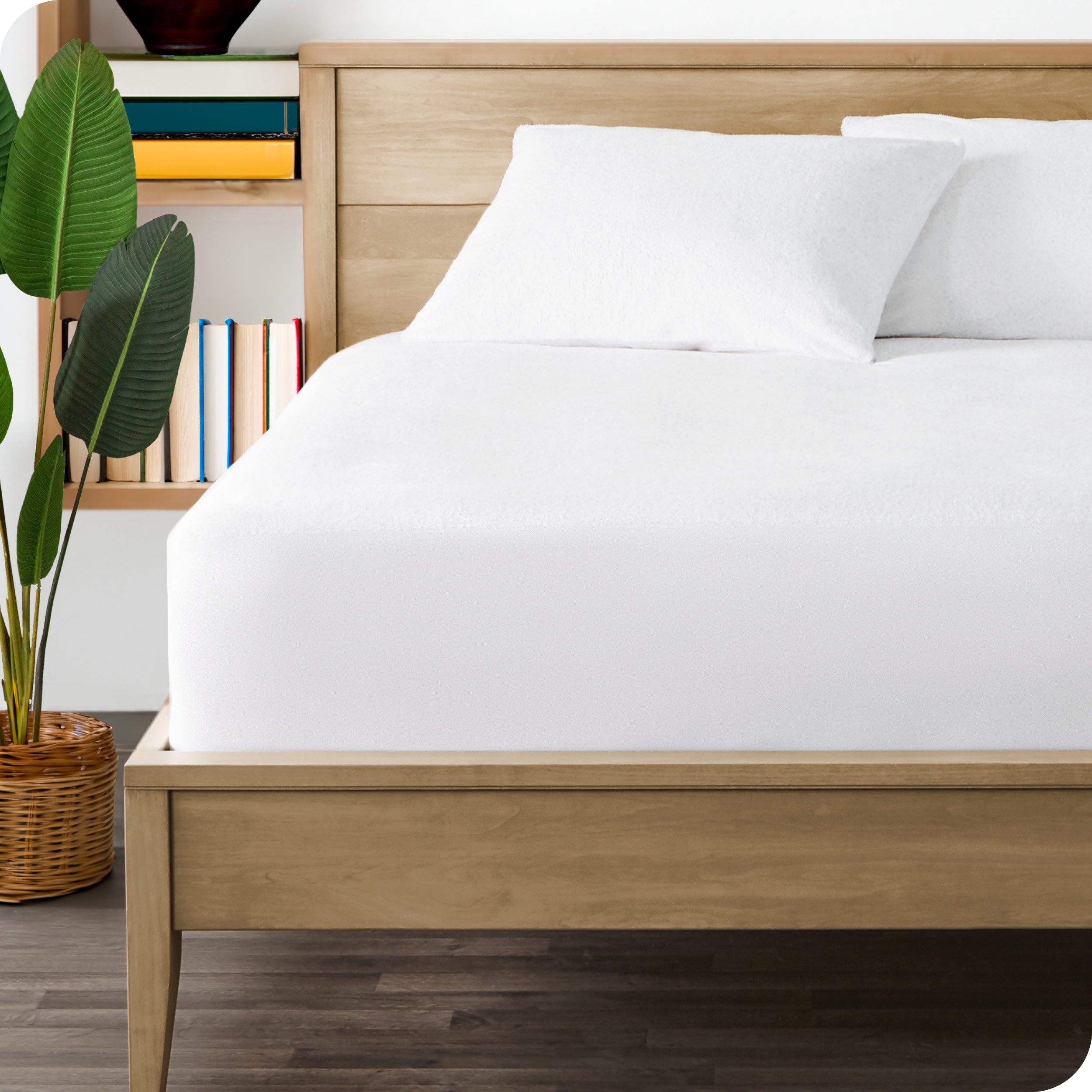 A bed made with a mattress protector