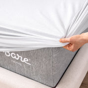 The corner of a mattress with a mattress protector putting on it