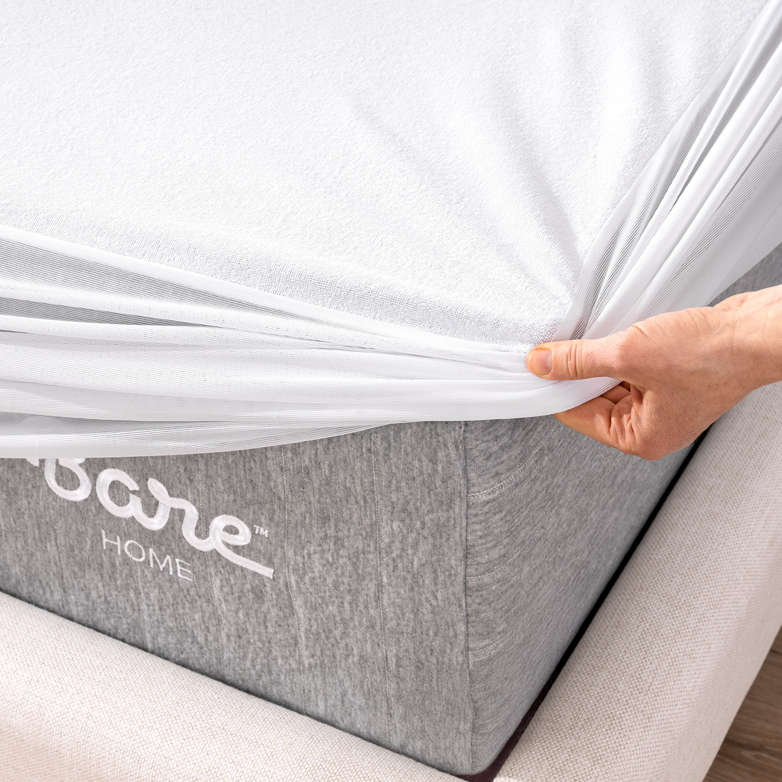 The corner of a mattress with a mattress protector putting on it