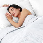 A woman sleeping with a weighted blanket over her body
