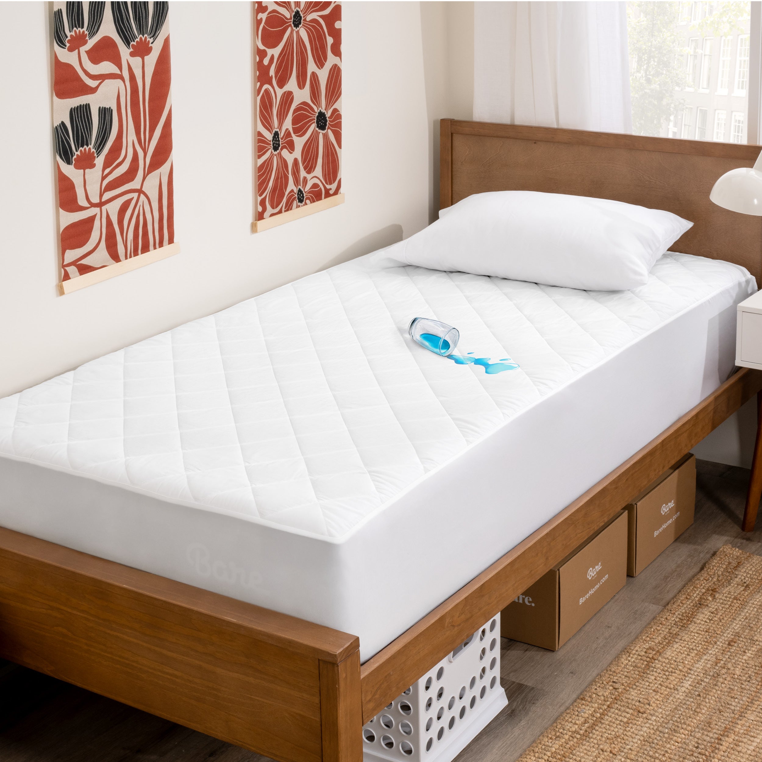 A glass of water spilled on a twin size mattress protector
