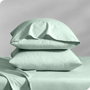 2 percale pillowcases on pillows set on a bed with matching sheets