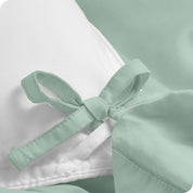 A close view of the corner tie of the duvet cover.