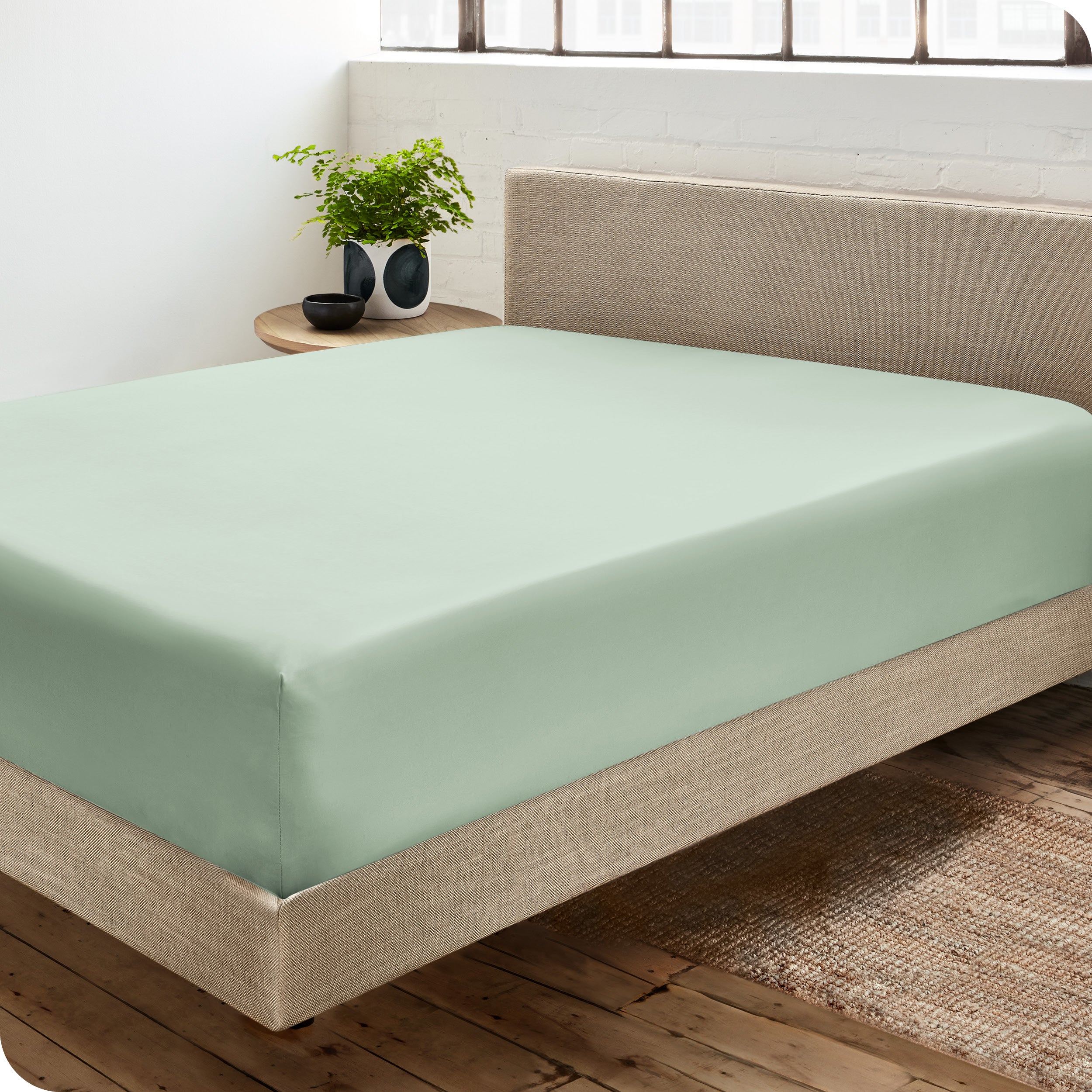 A sateen fitted sheet on a bed
