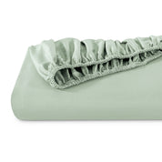 A single fitted sheet folded neatly showing part of the elastic