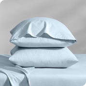 2 percale pillowcases on pillows set on a bed with matching sheets