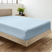 A single organic cotton fitted sheet on a bed
