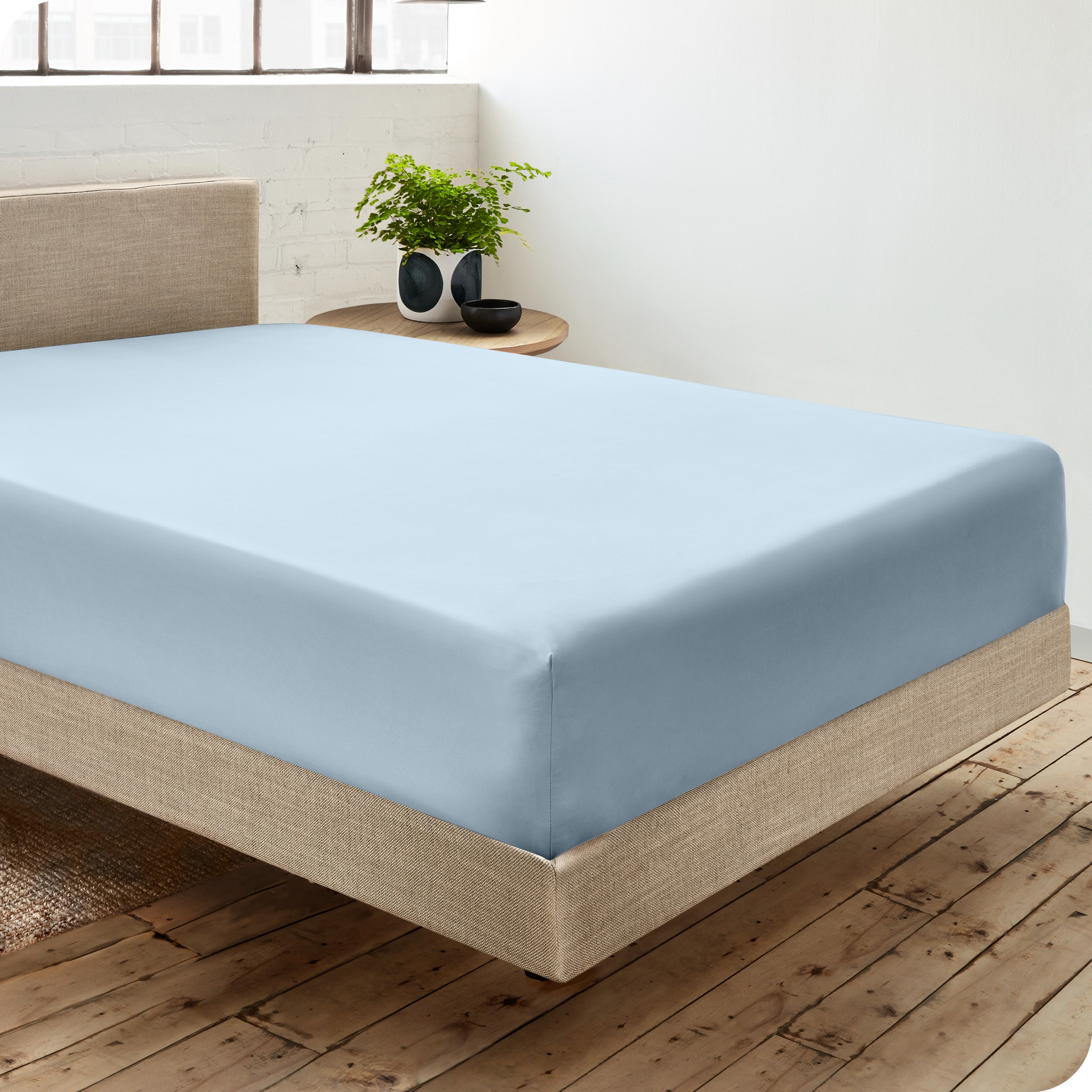 A single organic cotton fitted sheet on a bed
