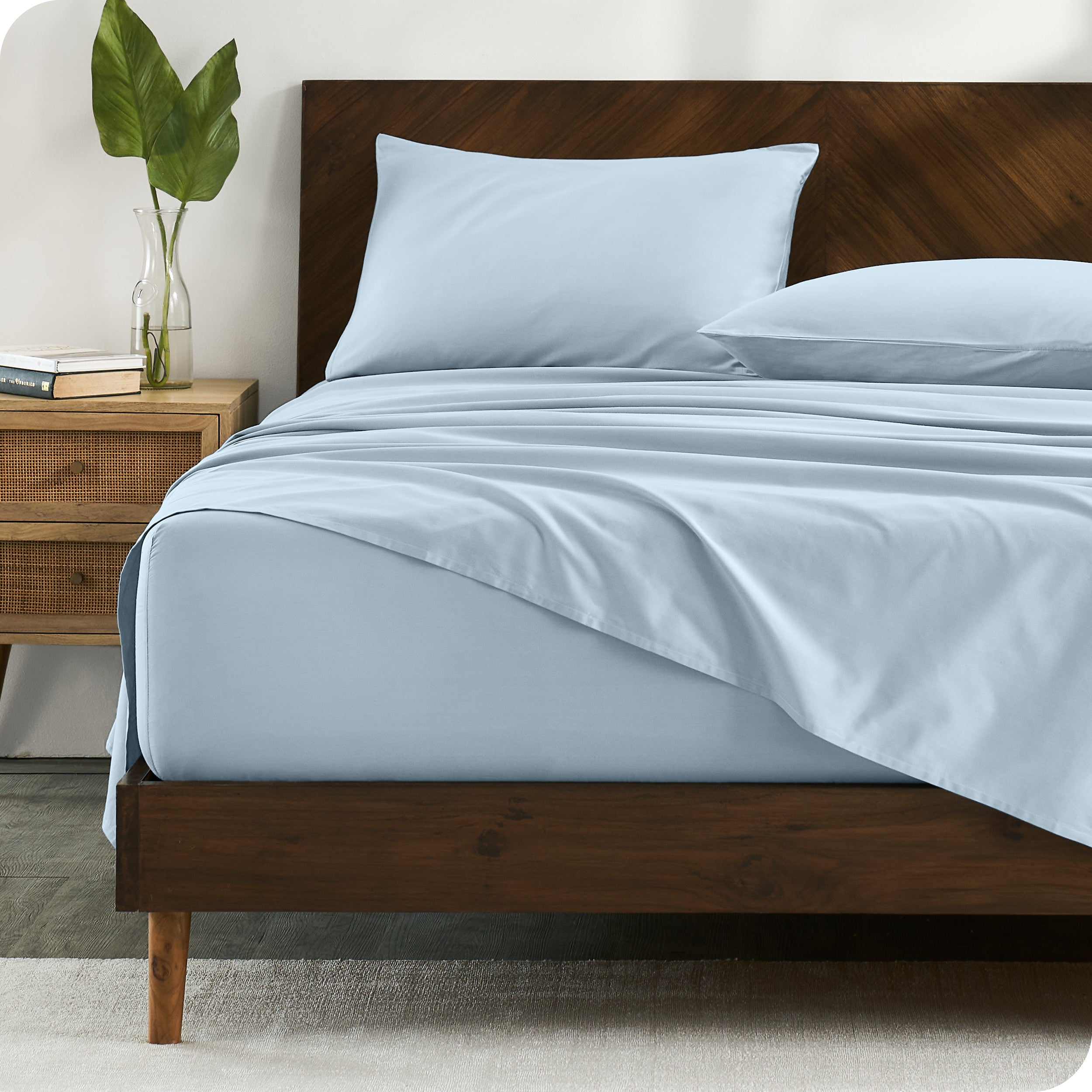 Percale sheets on bed in a modern bedroom