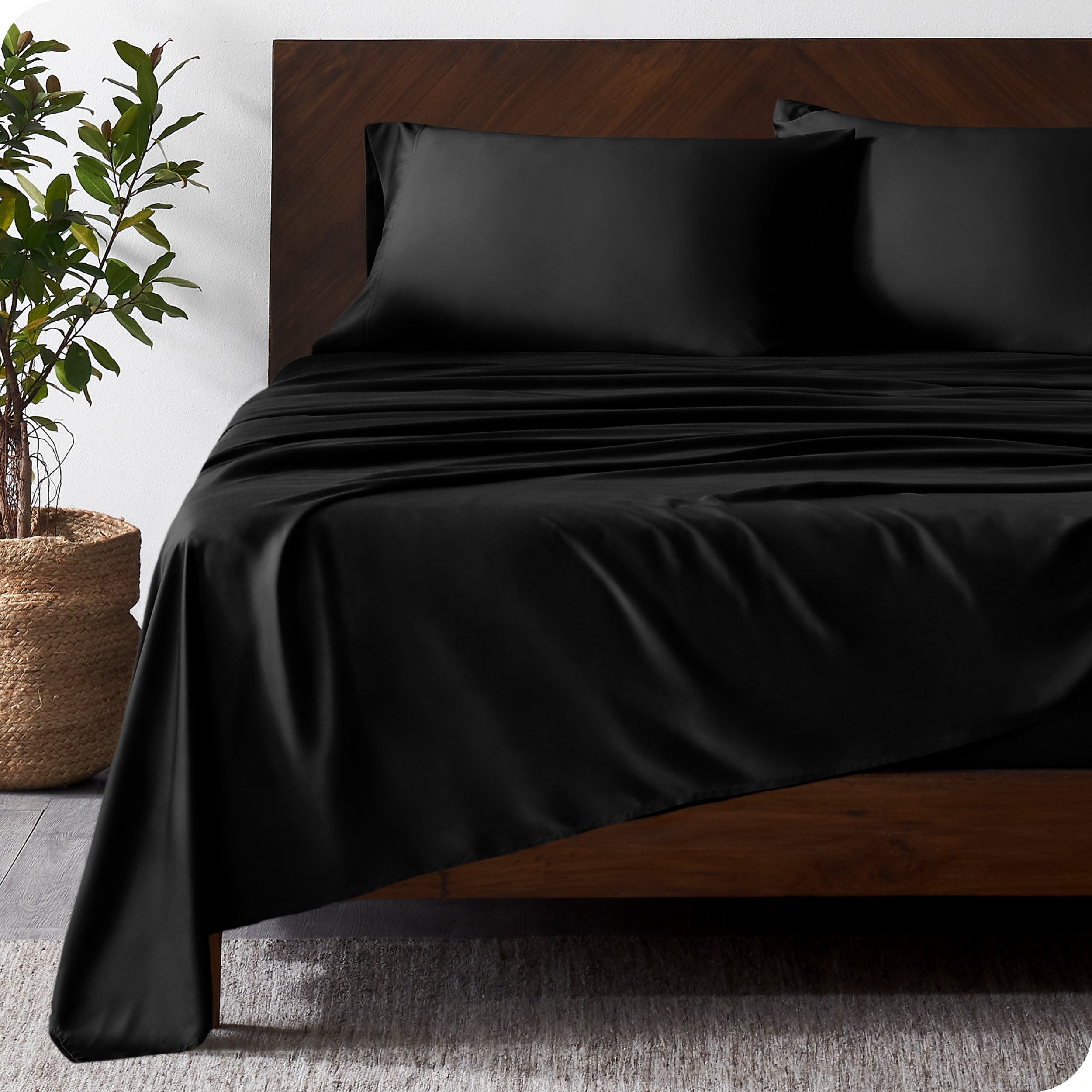 Wooden bed frame with bamboo sheets on the bed