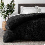 A black shaggy duvet cover on a bed