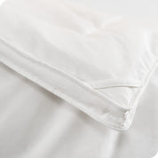 A corner of the down comforter showing the texture and lining.
