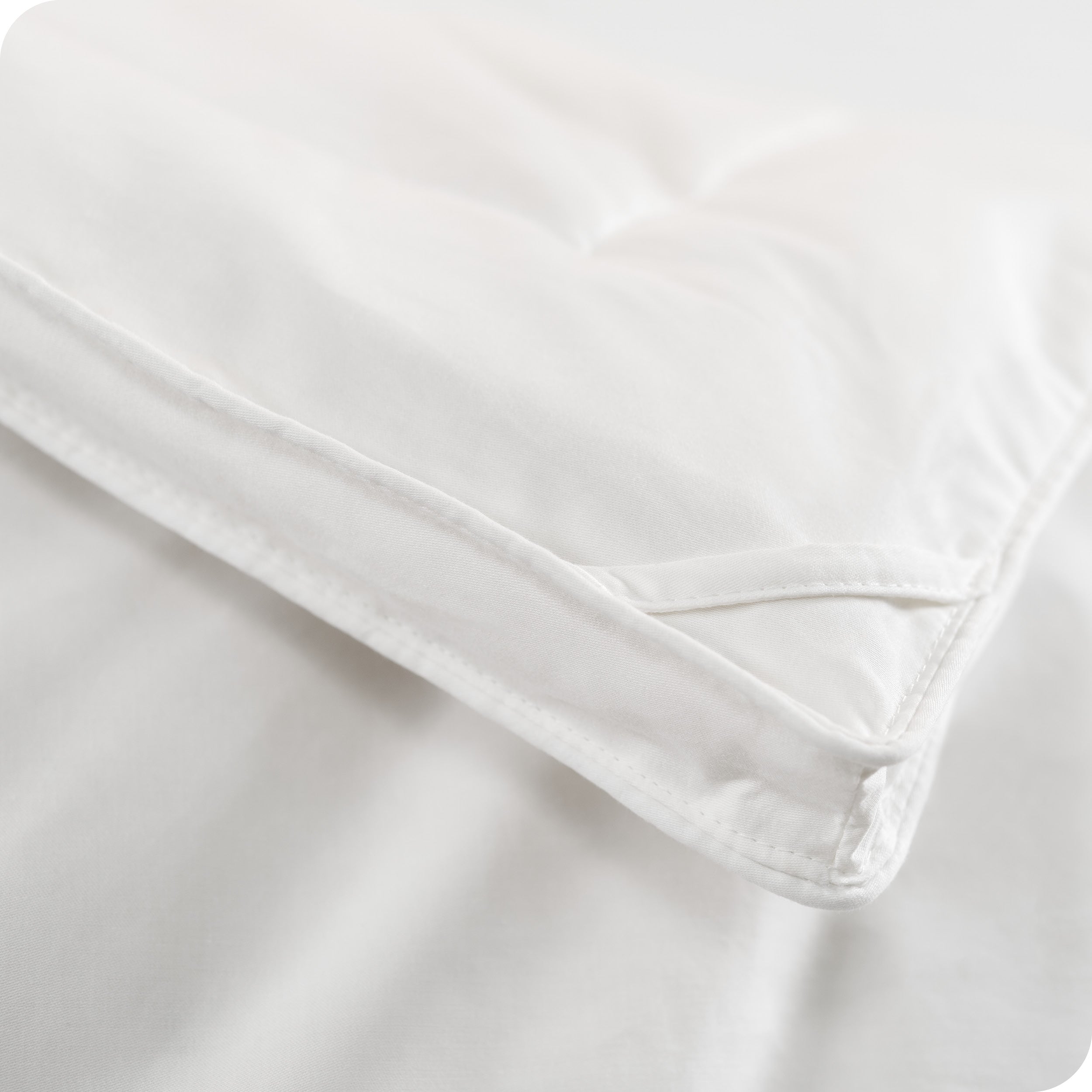 A corner of the down comforter showing the texture and lining.