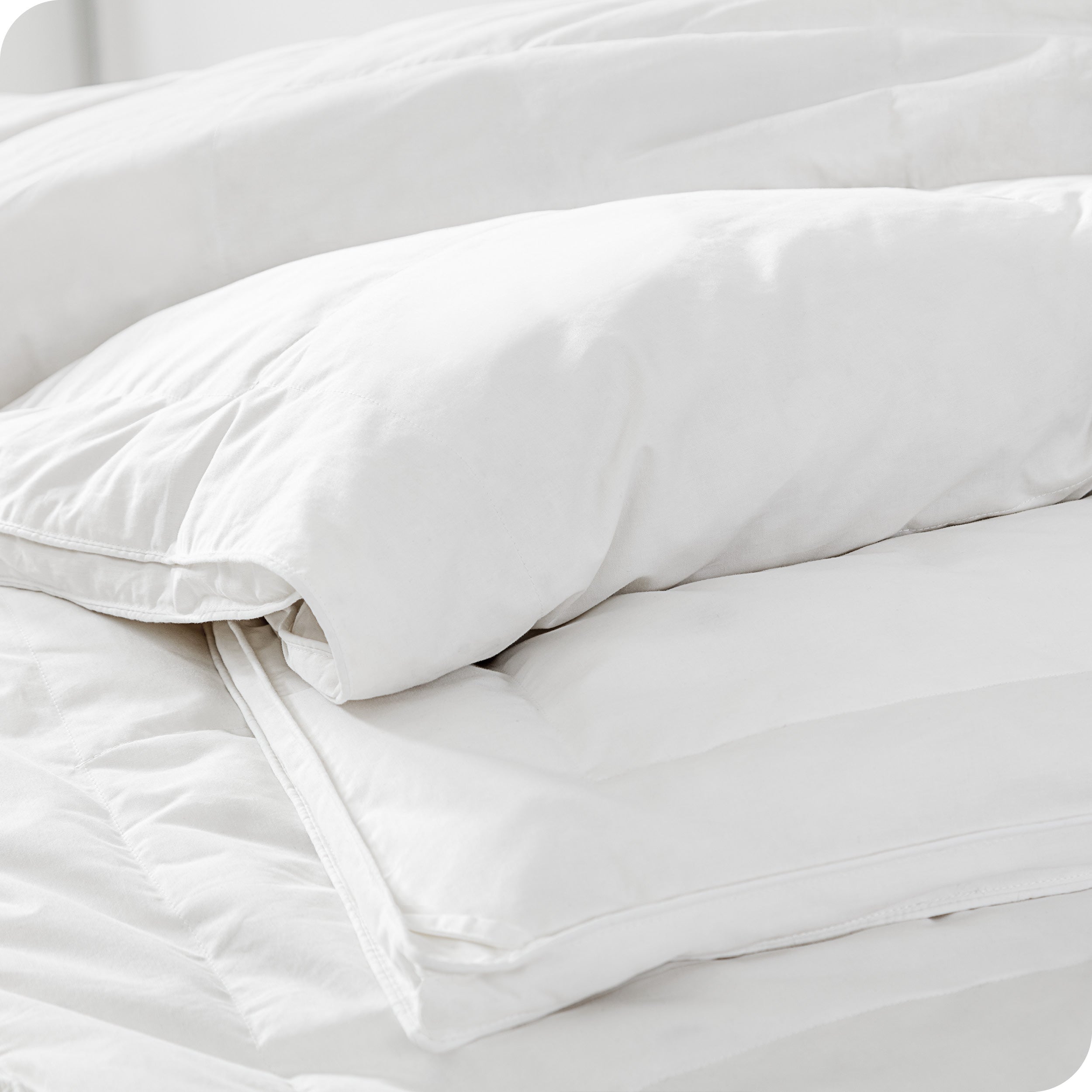 A corner of the down comforter showing the texture and lining.
