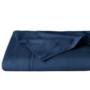 A folded dark blue microfiber flat sheet.