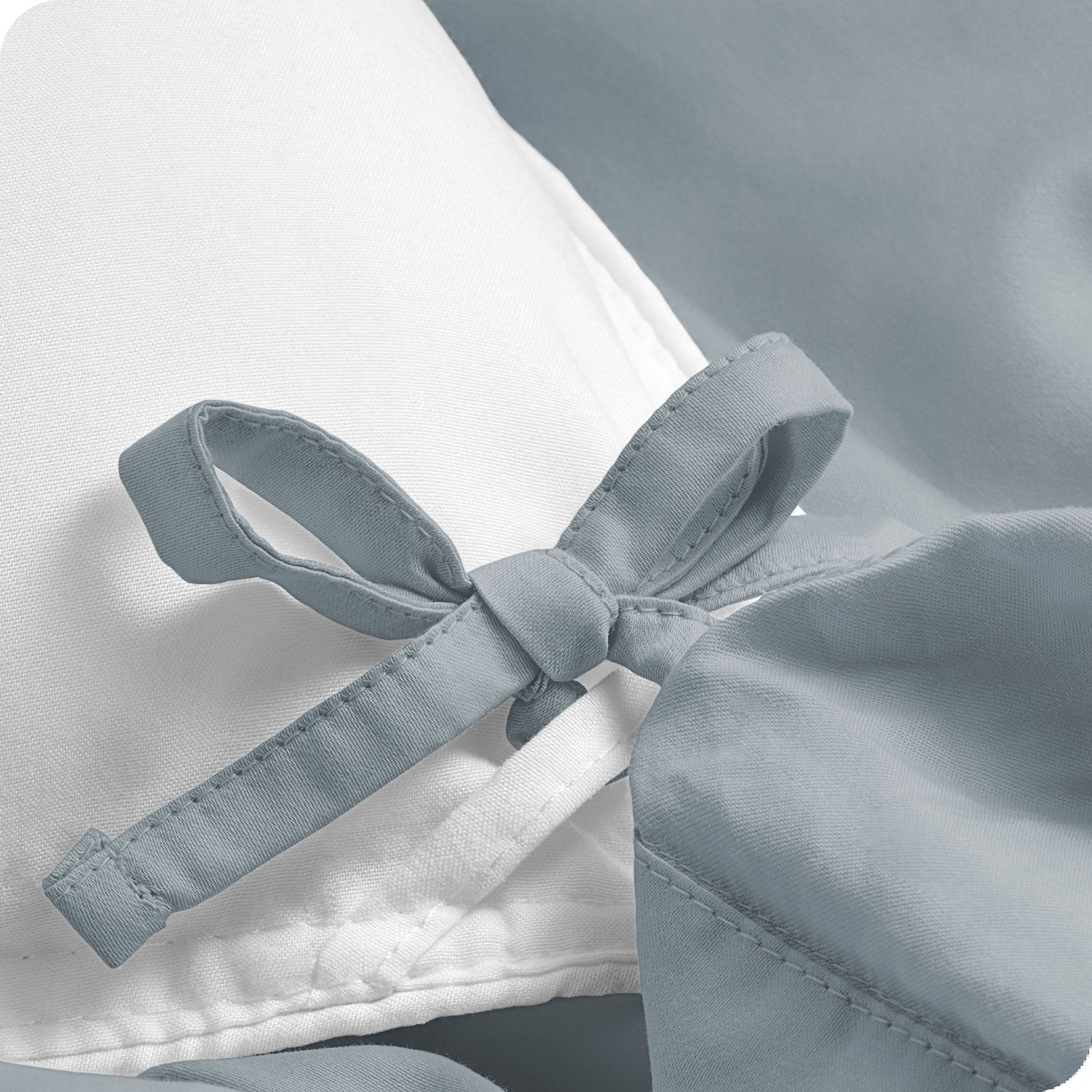 A close view of the corner tie of the duvet cover.