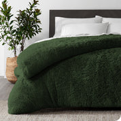 A green shaggy duvet cover on a bed