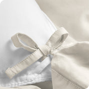 A close view of the corner tie of the duvet cover.
