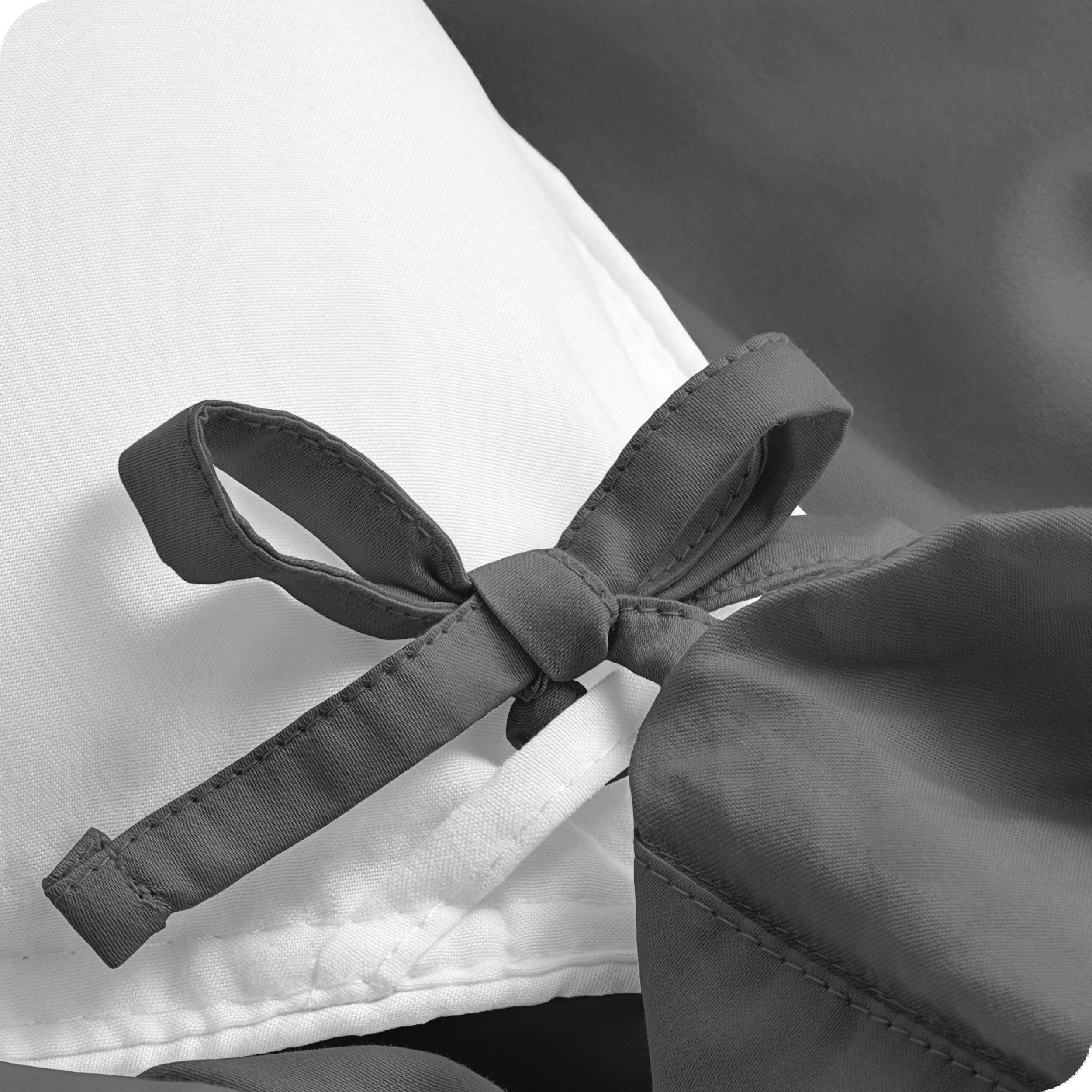 A close view of the corner tie of the duvet cover.
