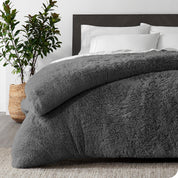 A grey shaggy duvet cover on a bed