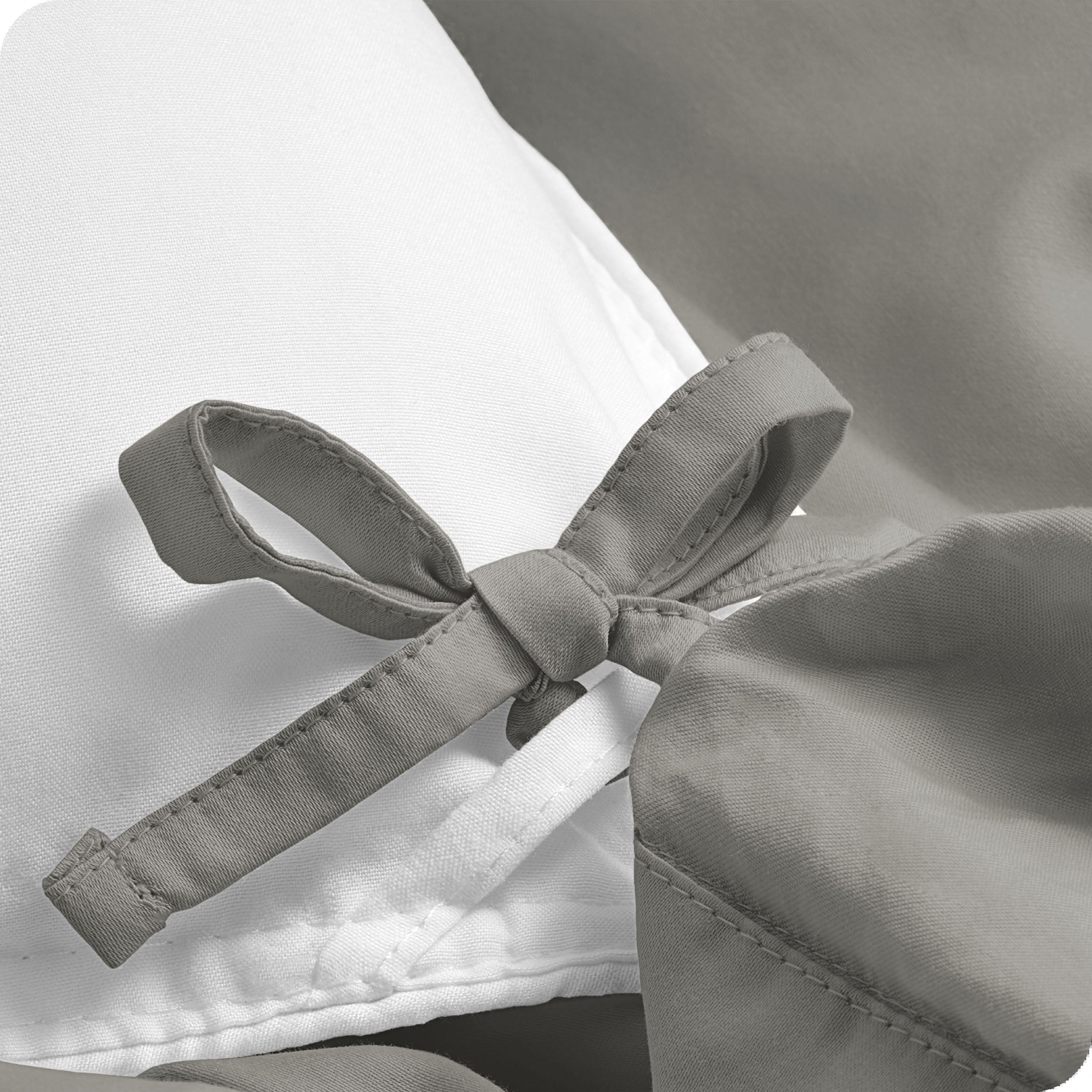 A close view of the corner tie of the duvet cover.