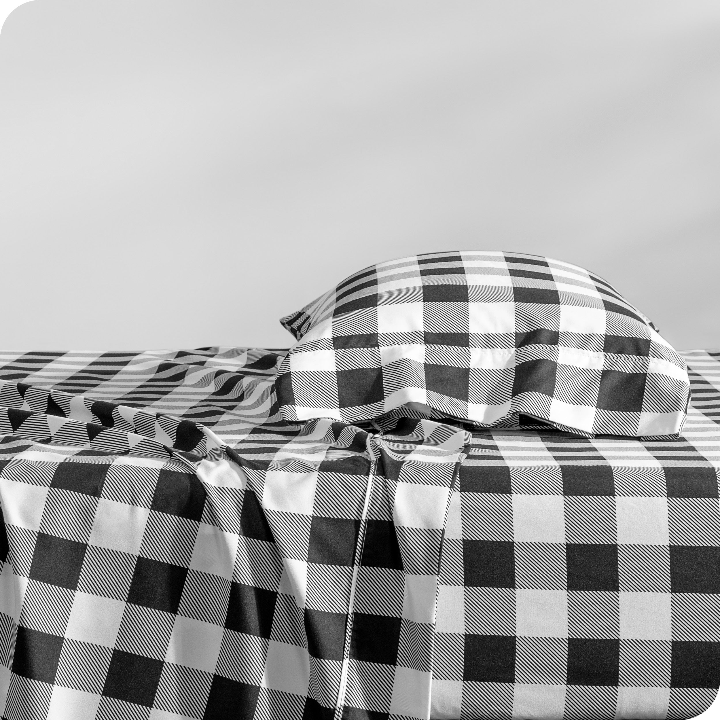 A side view of a bed with a pillow on top in our printed microfiber sheet set.
