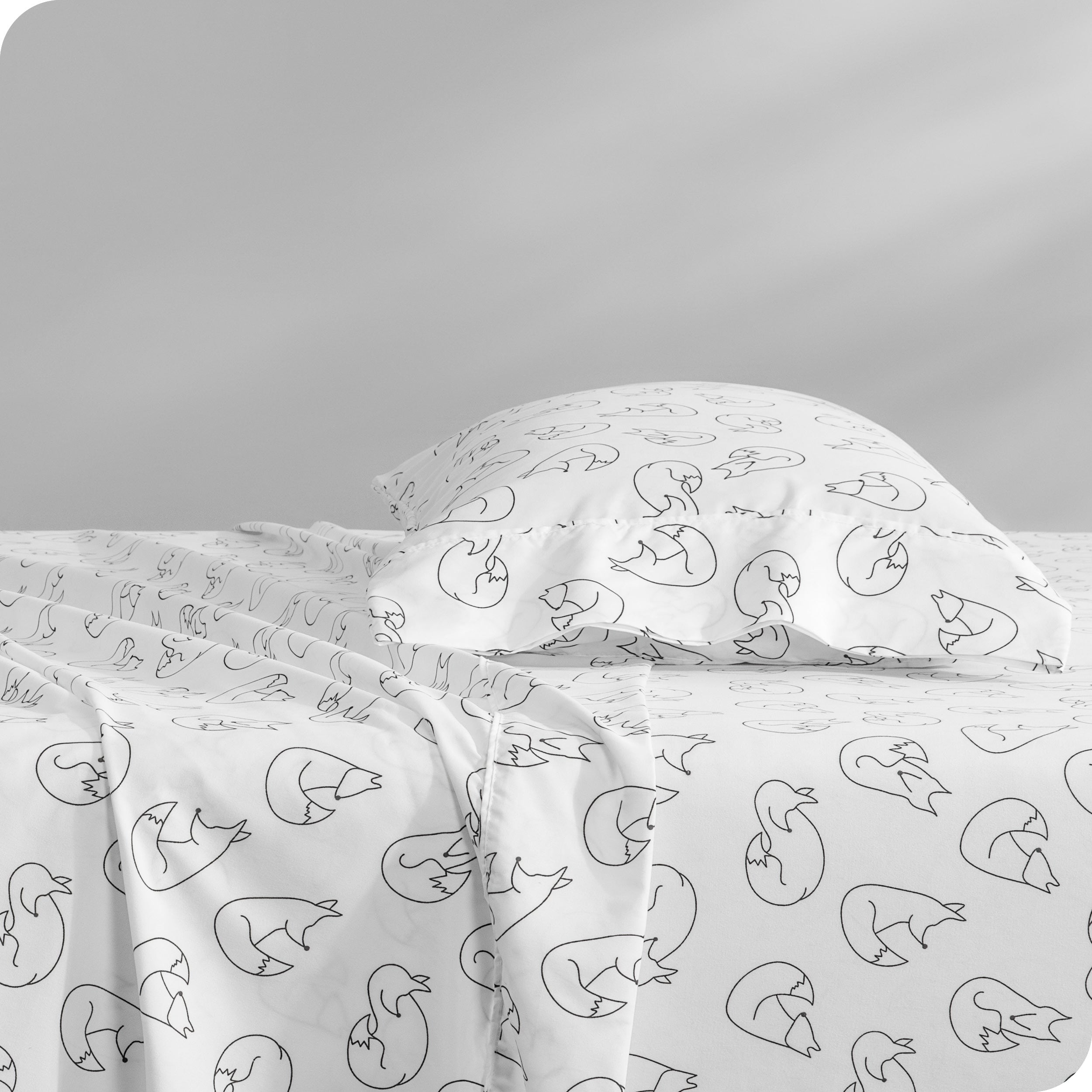 A side view of a bed with a pillow on top in our printed microfiber sheet set.