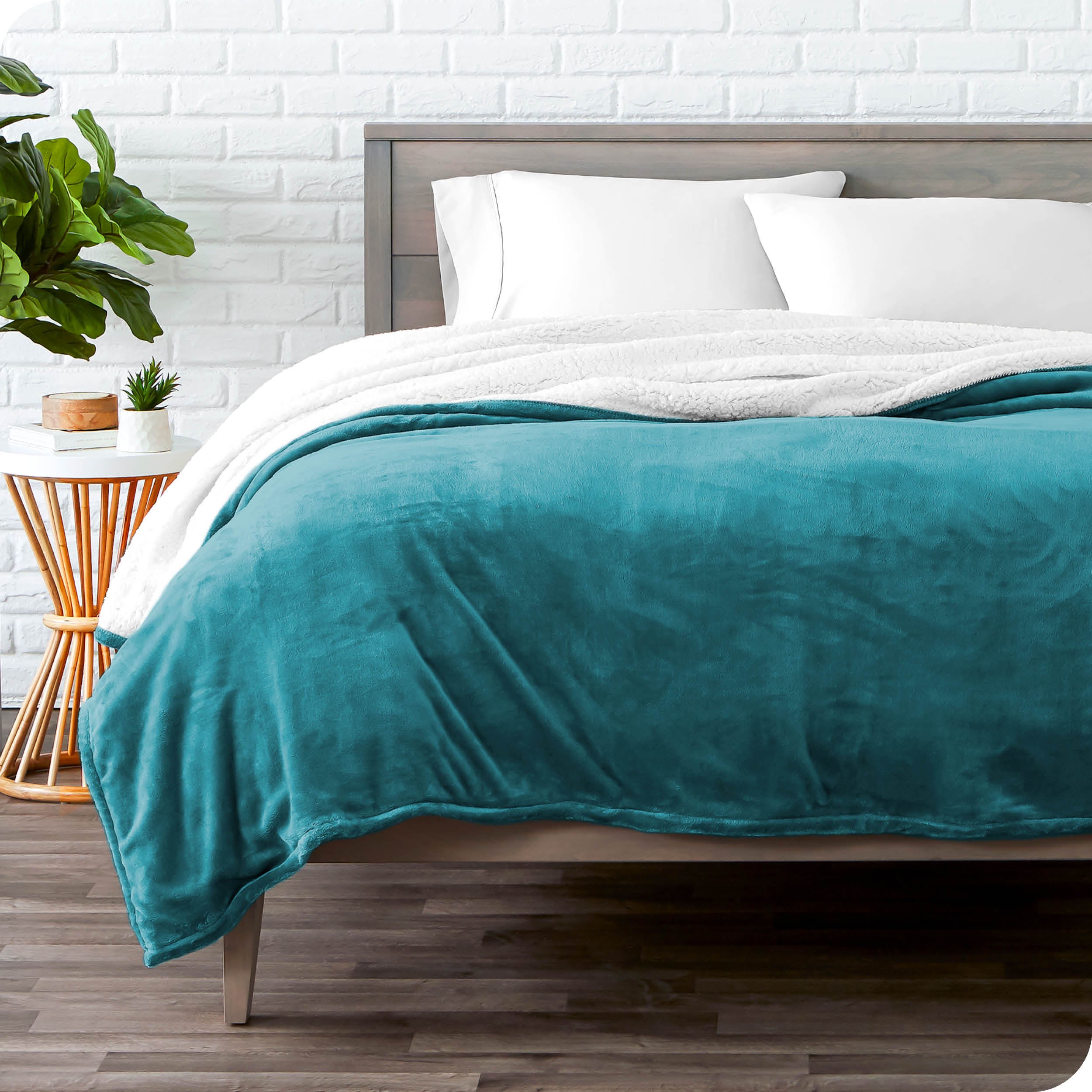 Blue Sherpa Blanket laying on a bed folded over itself part way