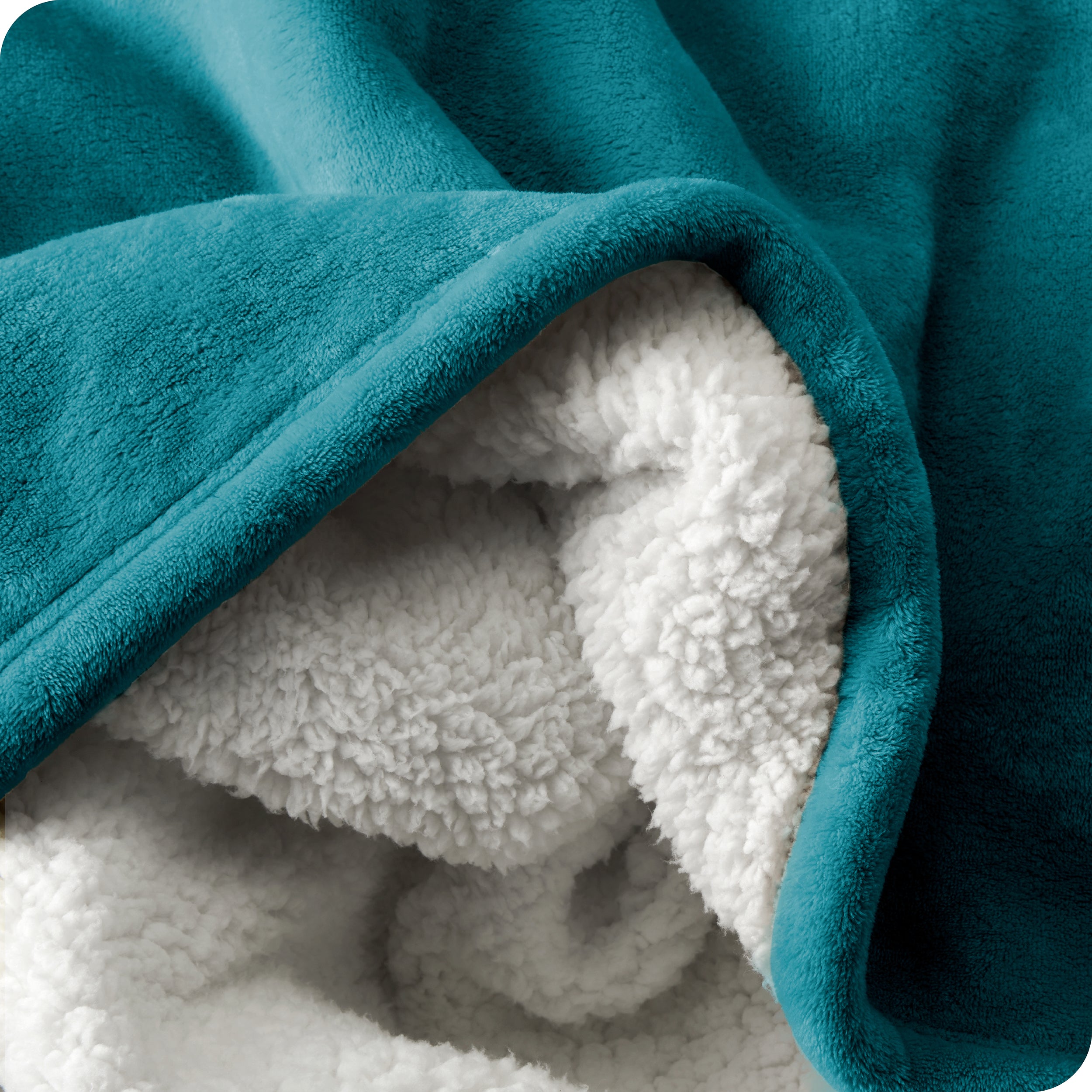 Close up of sherpa blanket showing texture of velvety soft side and sherpa backing