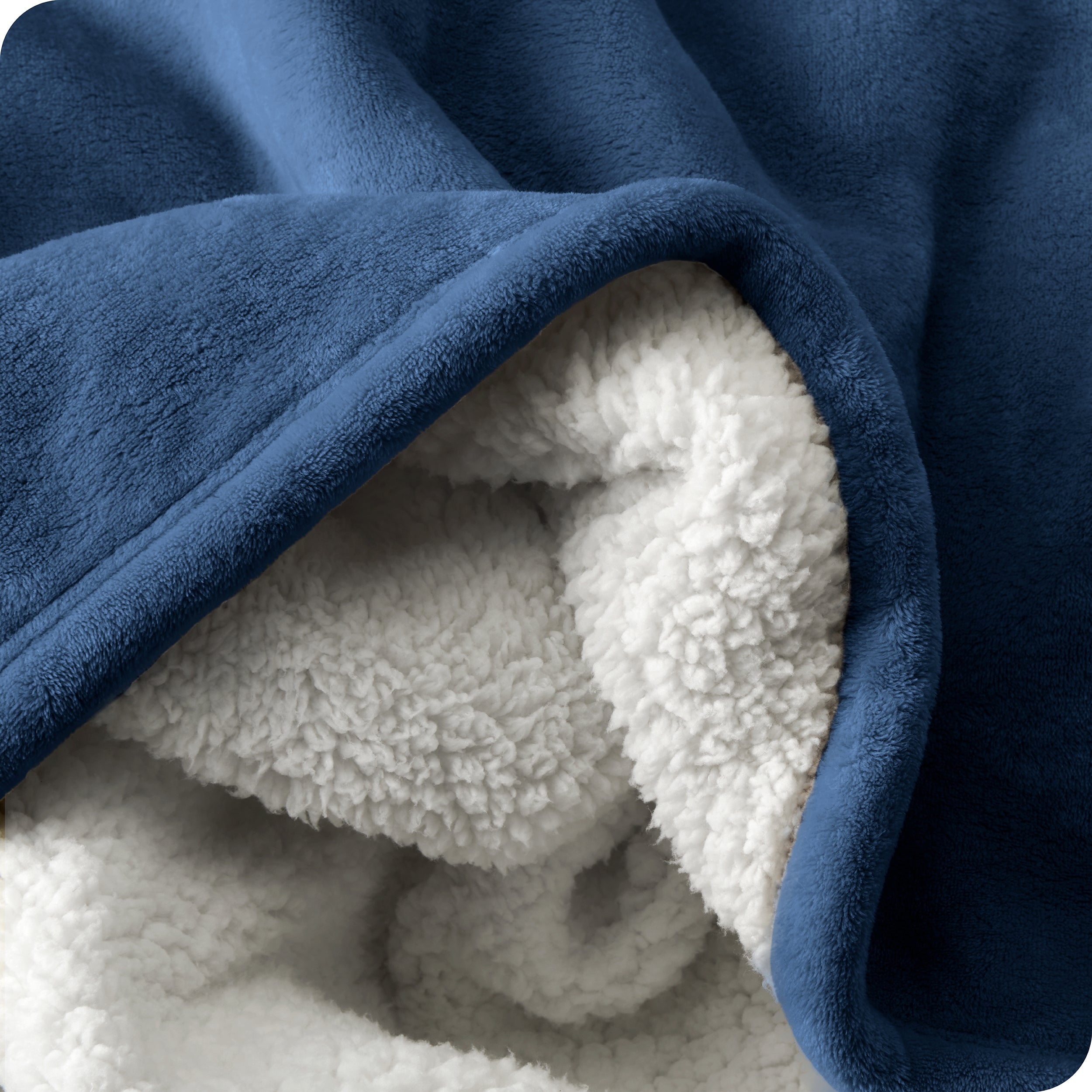 Close up of sherpa blanket showing texture of velvety soft side and sherpa backing