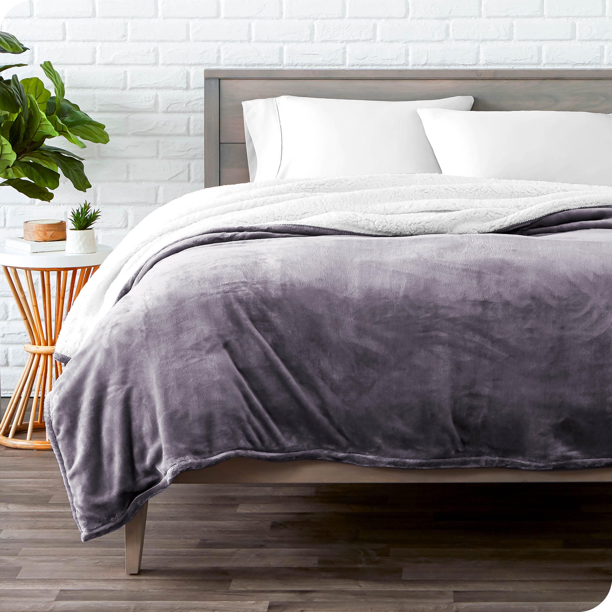 Purple Sherpa Blanket laying on a bed folded over itself part way