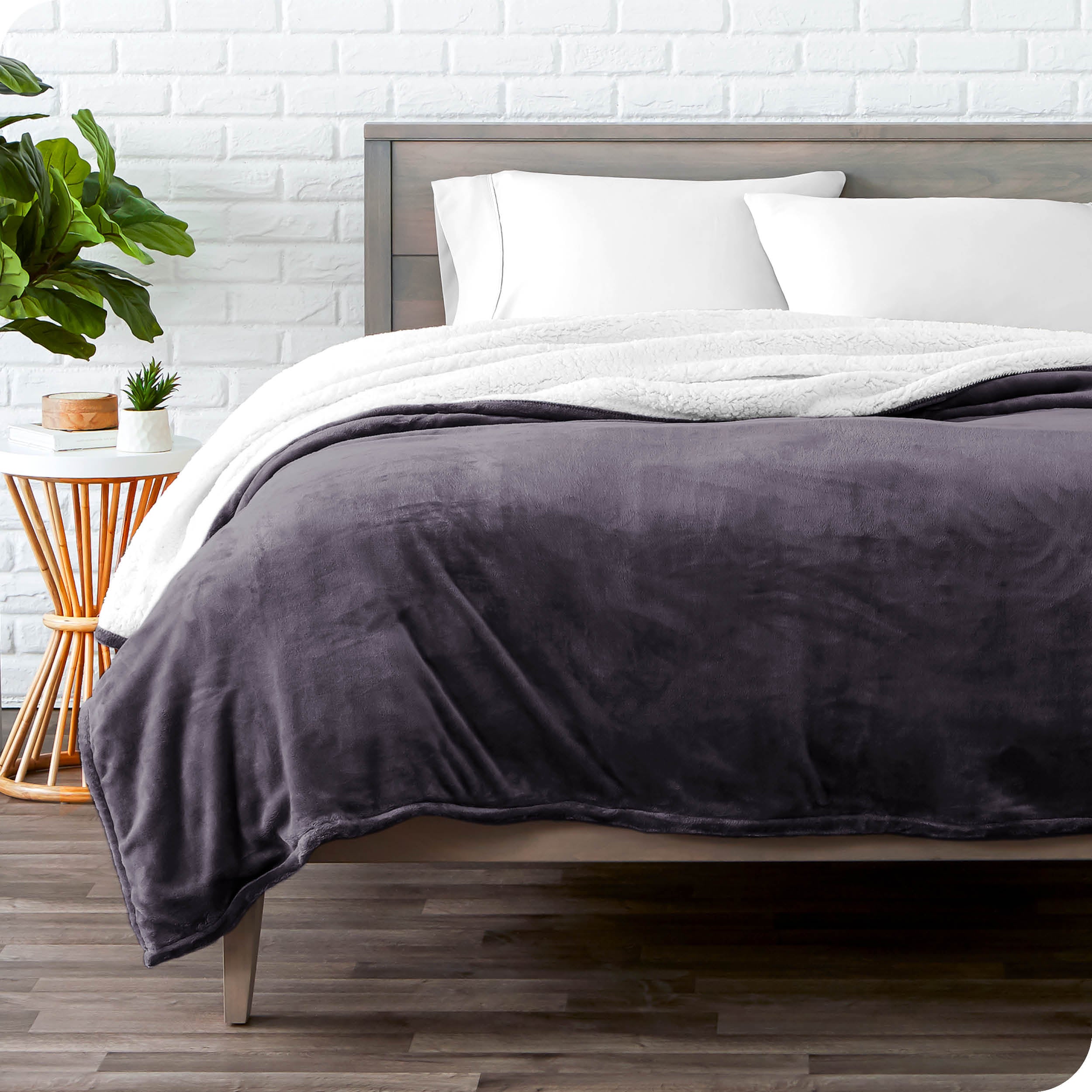 Purple Sherpa Blanket laying on a bed folded over itself part way