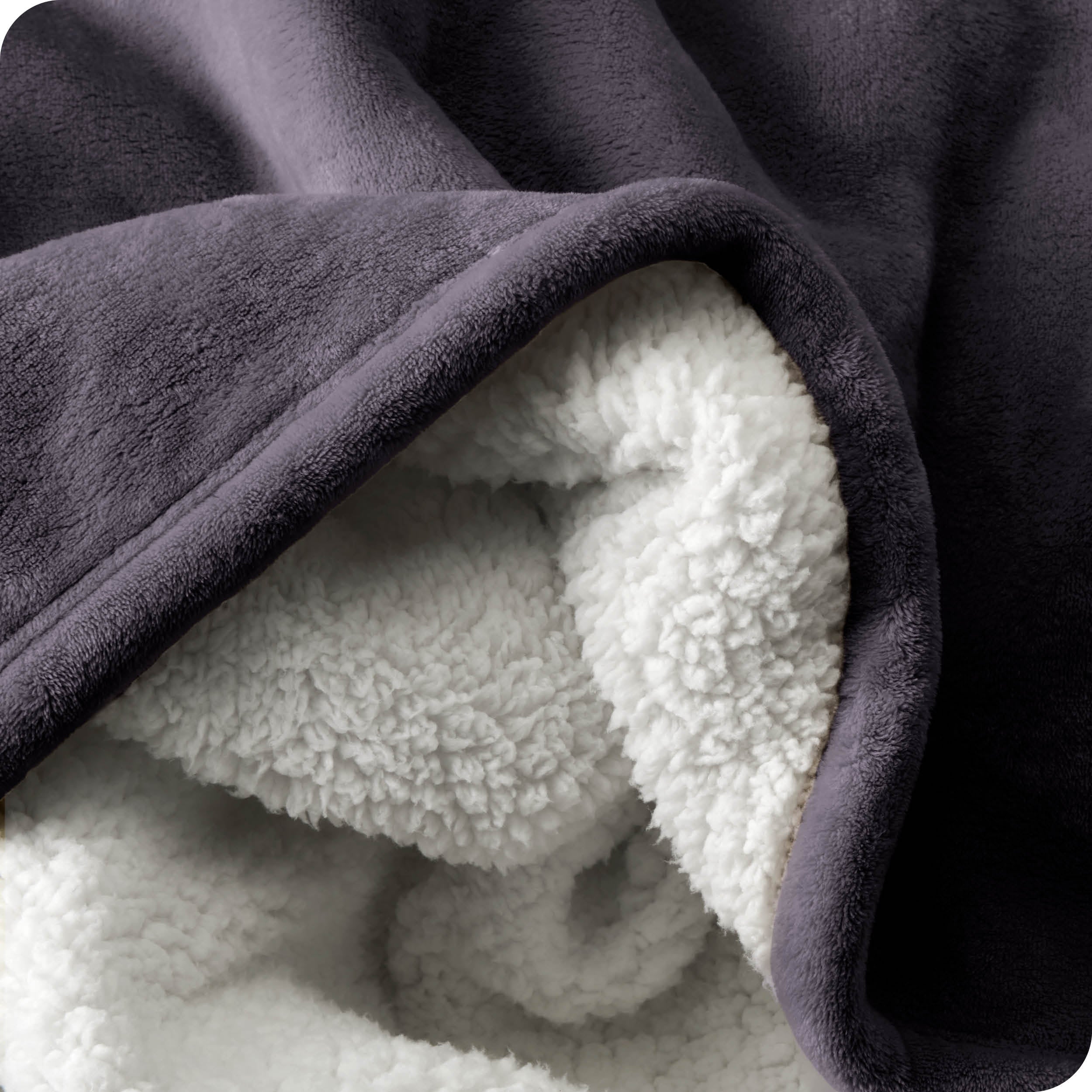 Close up of sherpa blanket showing texture of velvety soft side and sherpa backing