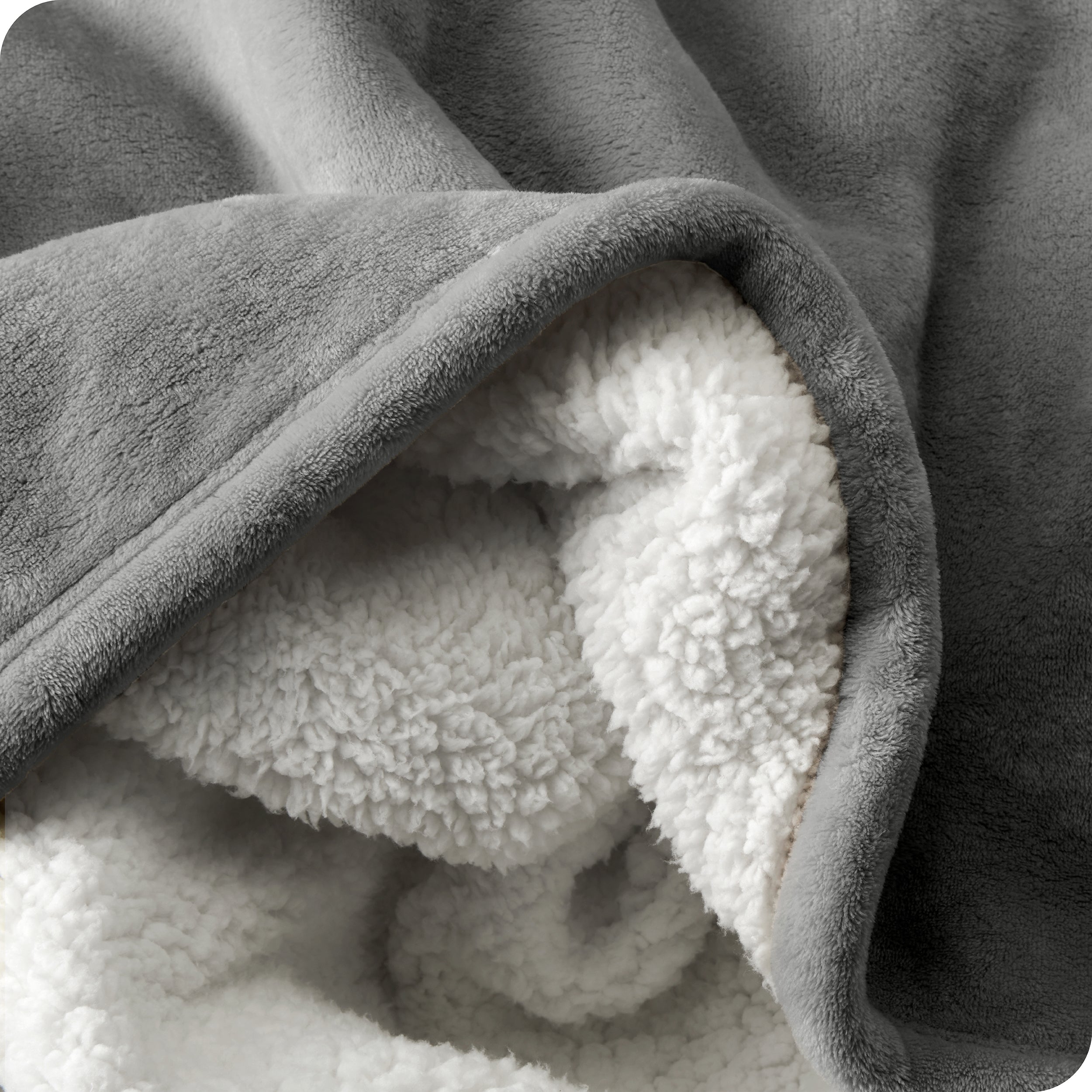 Close up of sherpa blanket showing texture of velvety soft side and sherpa backing