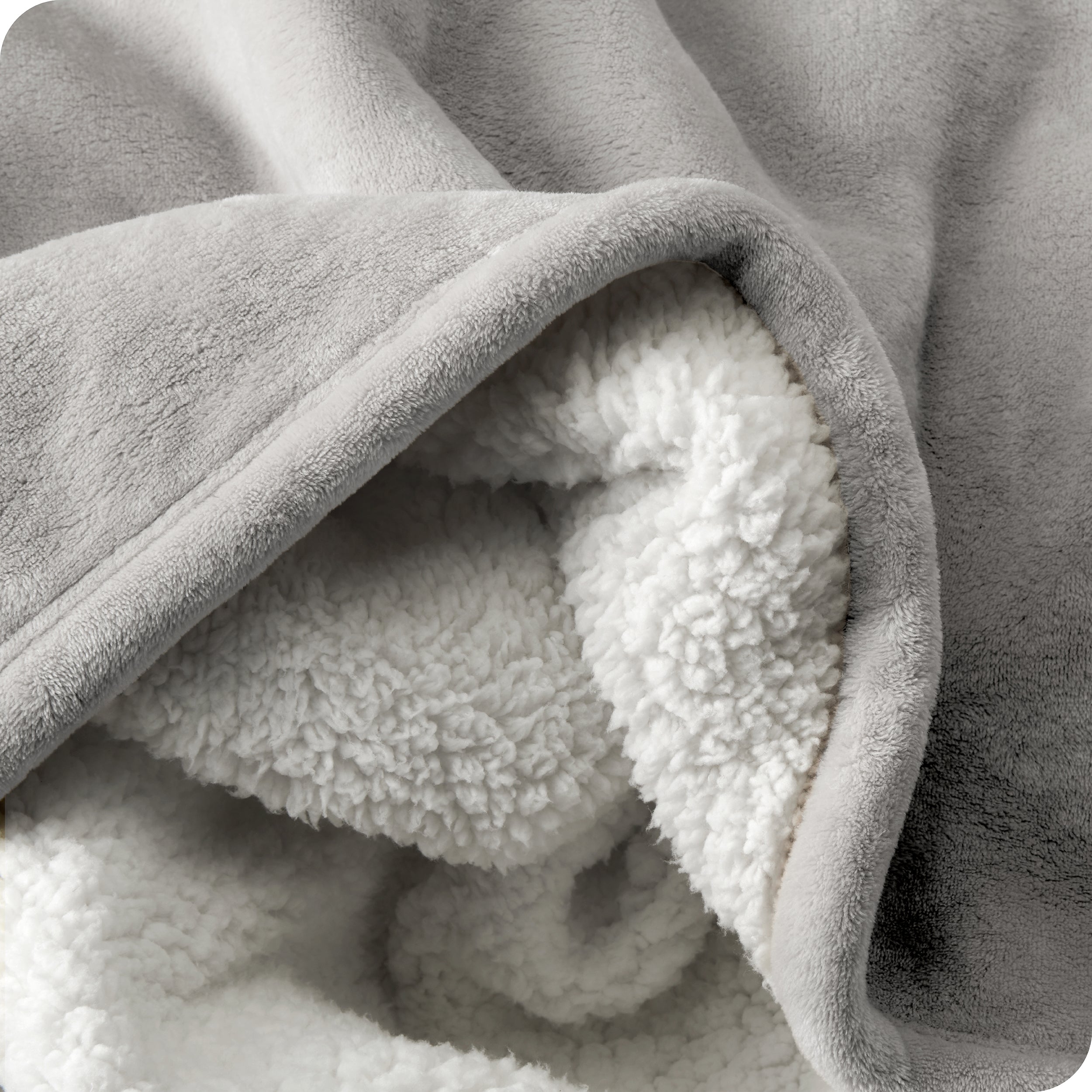 Close up of sherpa blanket showing texture of velvety soft side and sherpa backing