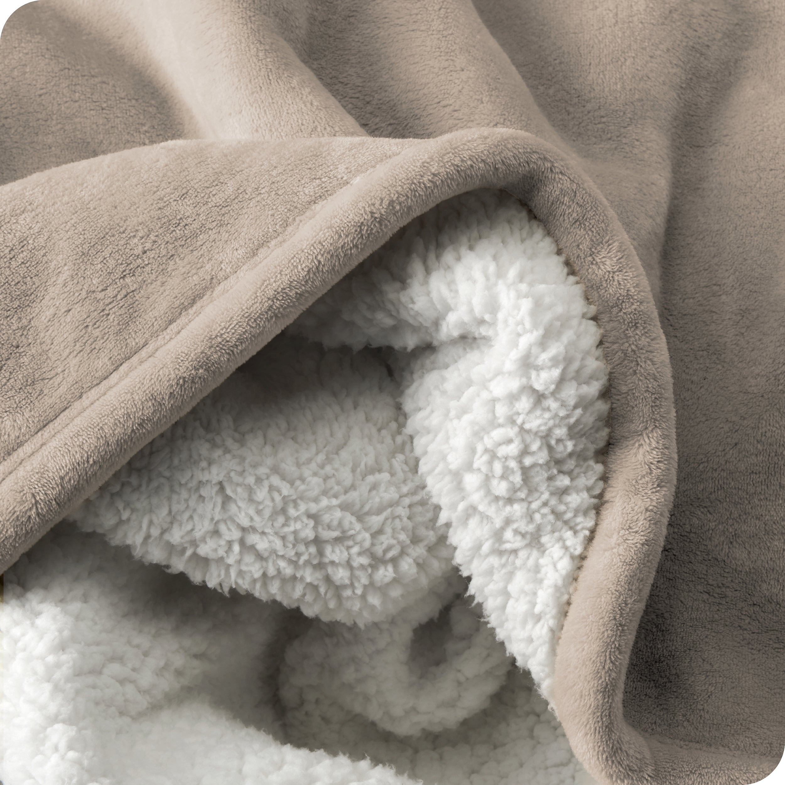 Close up of sherpa blanket showing texture of velvety soft side and sherpa backing