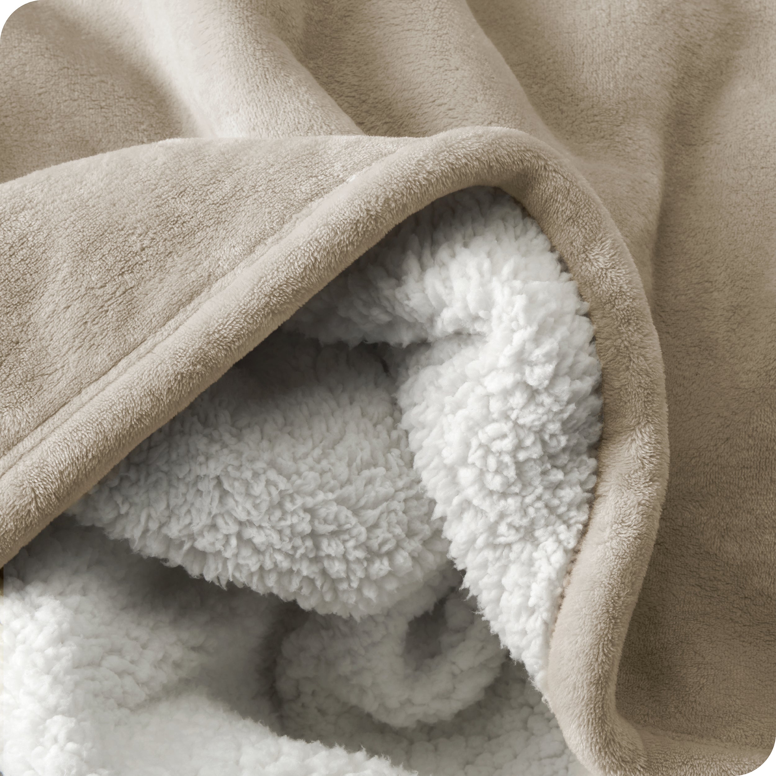 Close up of sherpa blanket showing texture of velvety soft side and sherpa backing
